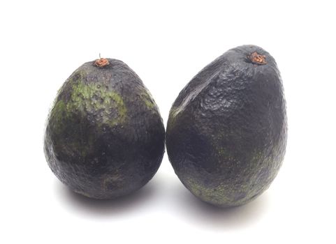 Two whole rotten avocados isolated on white background. 