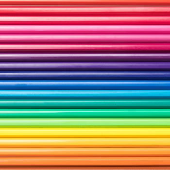 Close-up of a group of pencils arranged according to the light spectrum. Colorful background.