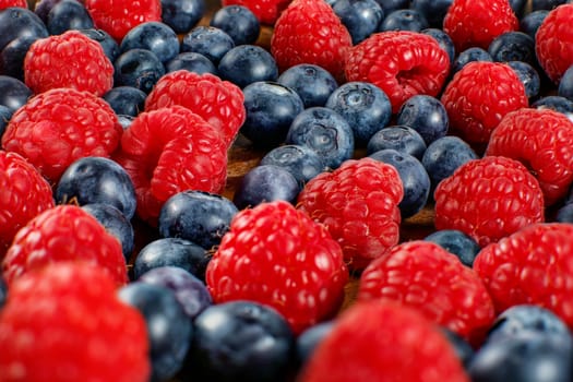 Closeup shot of mixed blueberries and raspberries.