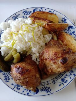 A plate of food with rice meat and vegetables. High quality photo