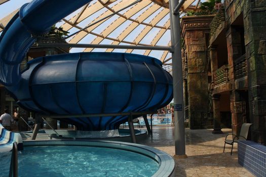 Huge blue slide and amazing interior architecture at Aquaticum in Budapest. High quality photo