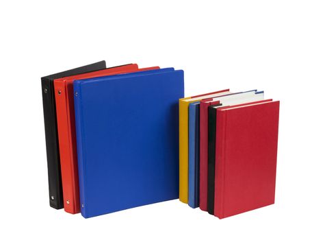 Horizontal shot of brightly colored notebooks and school books isolated on a white background. 