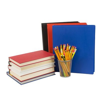 Beautiful photo of a stack of books next to some colorful notebooks and pencils in a pencil holder. Isolated on a white background. 