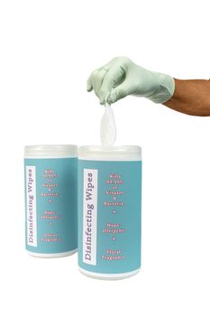 Vertical isolated on white shot of a rubber gloved hand pulling out a disinfecting wipe from container