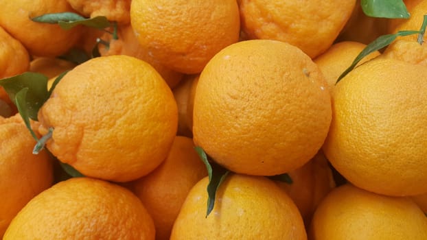 Healthy, fresh organic oranges in supermarket for sale, pile of orange in market for texture