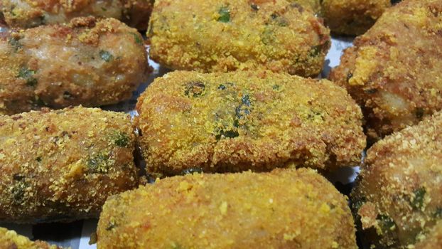 Closeup perspective view of home made spicy and delicious croquettes served with tea or other dishes during parties as fast food.