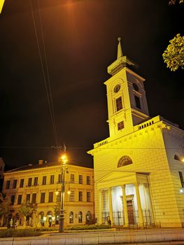 A clock tower in front of a building. High quality photo
