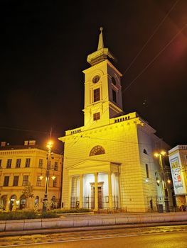 A clock tower in front of a building. High quality photo