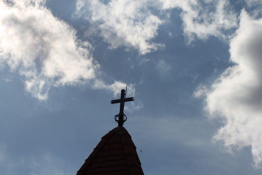 The cross on the dome of the temple and the beautiful blue sky. High quality photo