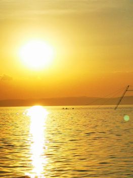 A sunset over a body of water. High quality photo