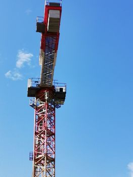 A crane next to a tower. High quality photo