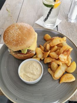 "Sombrero" hungarian burger with steak potatoes and garlic cream. High quality photo