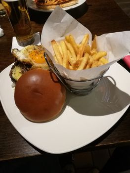 Hamburger served with fried eggs and baked potatoes.High quality photo