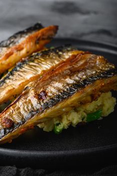 Roasted mackerel in paprika and saffron with mashed potatoes.on grey textured background.