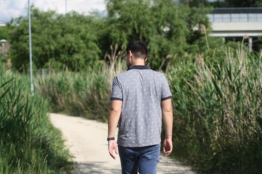 A young boy walking down the field. High quality photo