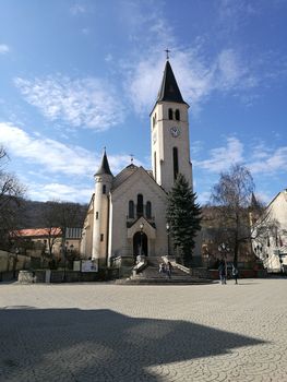 A church with a clock tower in front of a building. High quality photo