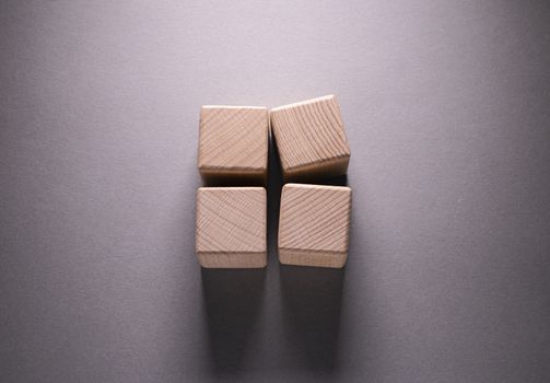 Wooden Geometric Shapes Cube on a paper background , This can use for past your words