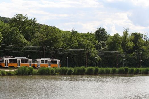 View of the tram and budafok lake with green trees. High quality photo