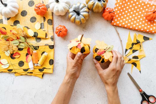 Step by step instruction of making halloween textile DIY pumpkin craft. Step 8 - pumpkins are ready, make two or three. Top view flat lay