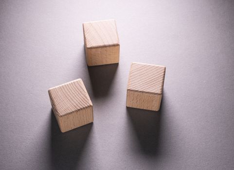 Wooden Geometric Shapes Cube on a paper background , This can use for past your words