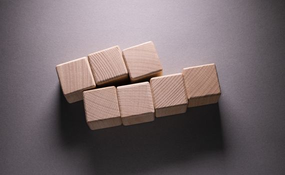 Wooden Geometric Shapes Cube on a paper background , This can use for past your words