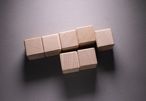 Wooden Geometric Shapes Cube on a paper background , This can use for past your words