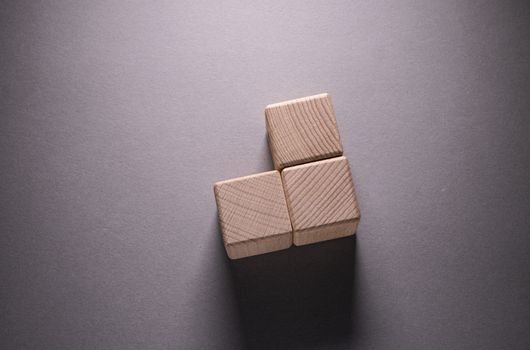 Wooden Geometric Shapes Cube on a paper background , This can use for past your words