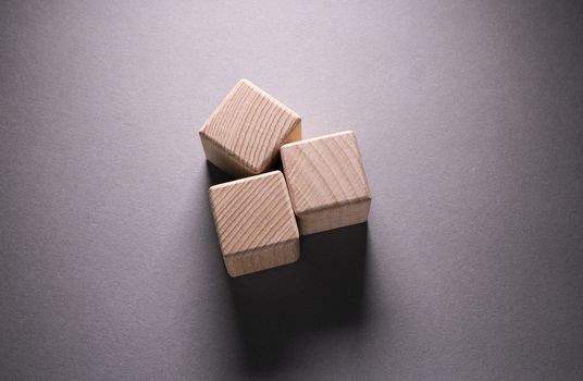 Wooden Geometric Shapes Cube on a paper background , This can use for past your words