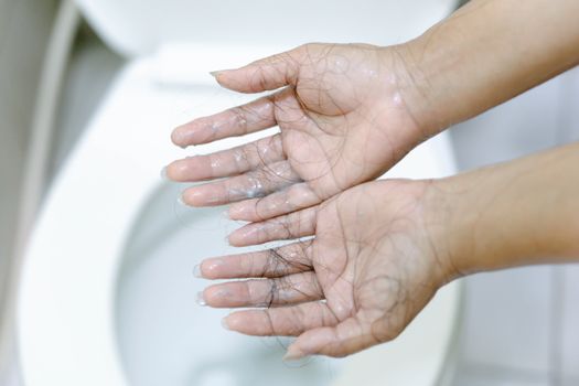 Closeup Hair loss on woman hand in the bathroom