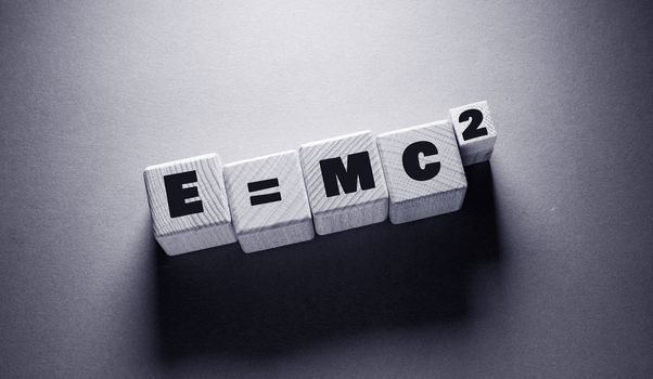 E = mc 2 Word Written on Wooden Cubes