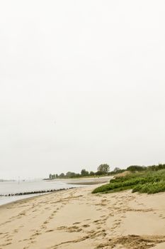 Rough and cold Weser beach in Brake Unterweser Lower Saxony Germany. Harrier Sand.