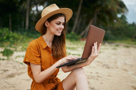woman tourist with laptop on island palm trees tropics fresh air