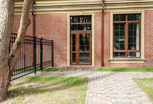 new house with plastic windows and doors in a residential area on summer day