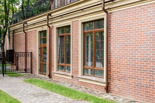 new house with plastic windows and doors in a residential area on summer day