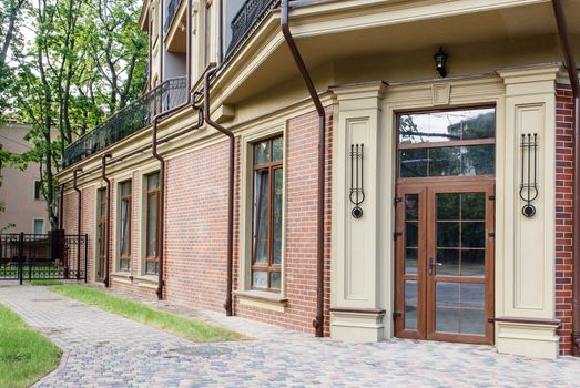 new house with plastic windows and doors in a residential area on summer day