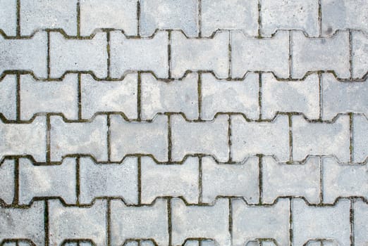 road paved with sidewalk tiles. beautiful brick background with, masonry texture of light gray bricks. outdoor closeup