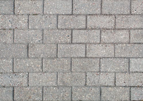 road paved with sidewalk tiles. beautiful brick background with, masonry texture of light gray bricks. outdoor closeup