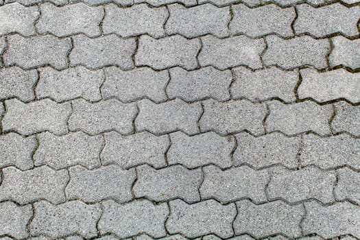 road paved with sidewalk tiles. beautiful brick background with, masonry texture of light gray bricks. outdoor closeup