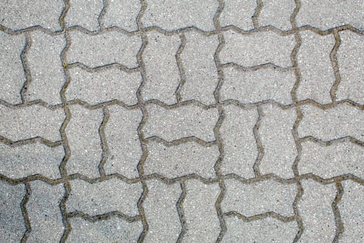 road paved with sidewalk tiles. beautiful brick background with, masonry texture of light gray bricks. outdoor closeup