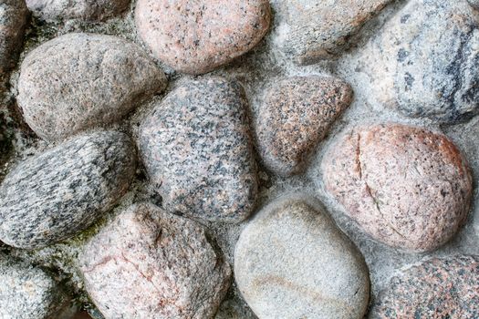 pavement of granite stone.old cobblestone road pavement texture. absrtact background. outdoor closeup