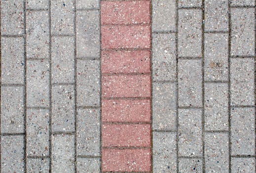 road paved with sidewalk tiles. beautiful brick background with, masonry texture of light brown and gray bricks. outdoor closeup