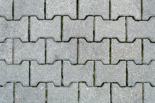 road paved with sidewalk tiles. beautiful brick background with, masonry texture of light gray bricks. outdoor closeup