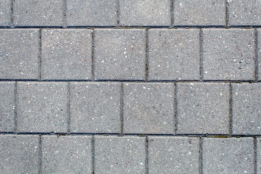 road paved with sidewalk tiles. beautiful brick background with, masonry texture of light gray bricks. outdoor closeup