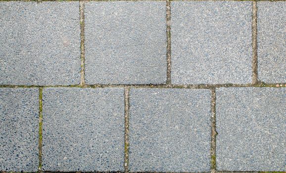 road paved with sidewalk tiles. beautiful brick background with, masonry texture of light gray bricks. outdoor closeup