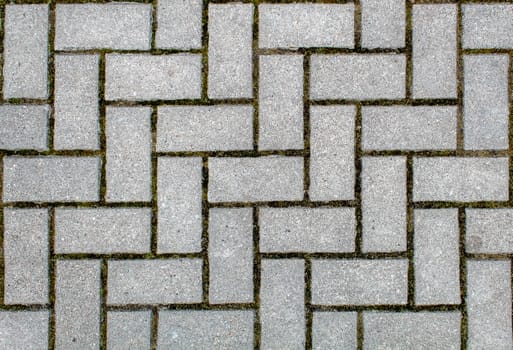 road paved with sidewalk tiles. beautiful brick background with, masonry texture of light gray bricks. outdoor closeup