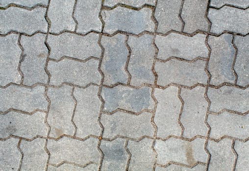 road paved with sidewalk tiles. beautiful brick background with, masonry texture of light gray bricks. outdoor closeup