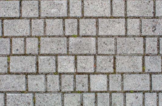 road paved with sidewalk tiles. beautiful brick background with, masonry texture of light gray bricks. outdoor closeup