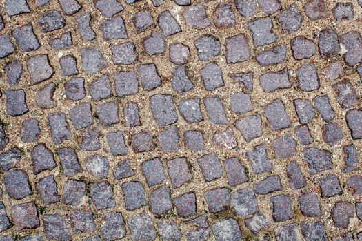 pavement of granite stone.old cobblestone road pavement texture. absrtact background. outdoor closeup