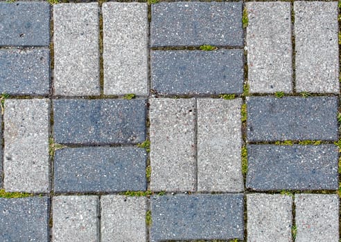 road paved with sidewalk tiles. beautiful brick background with, masonry texture of light and dark gray bricks. outdoor closeup