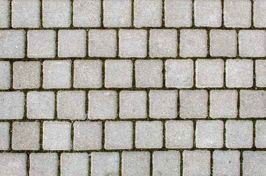 road paved with sidewalk tiles. beautiful brick background with, masonry texture of light gray bricks. outdoor closeup